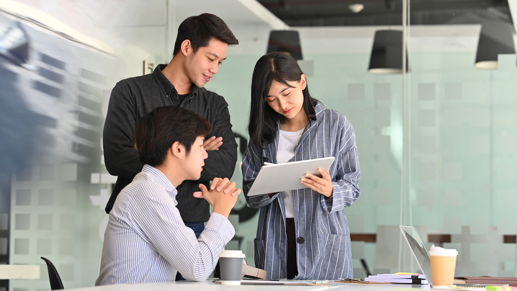 Group of coworkers at meeting, applying strategies for global team management