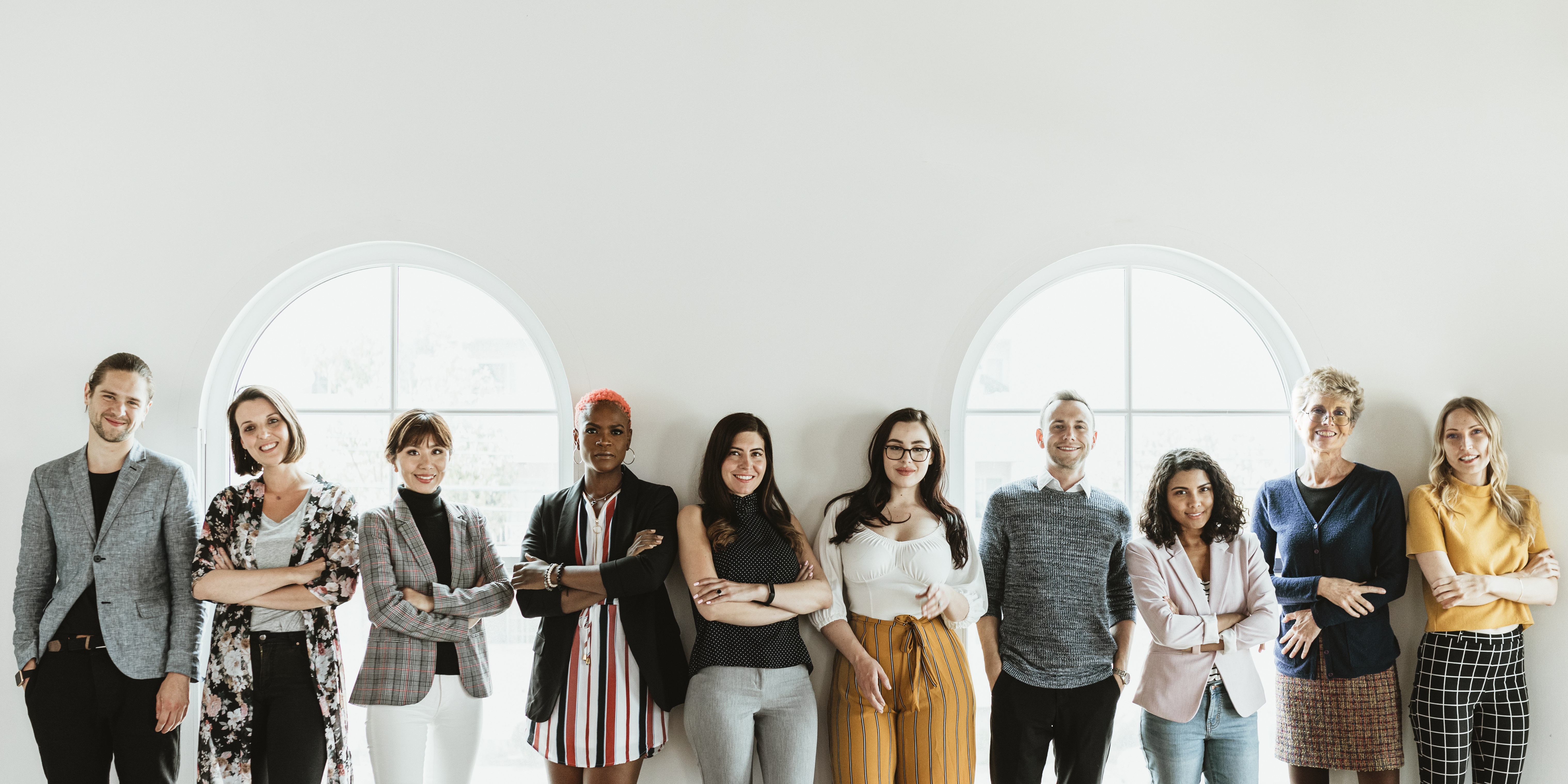 A diverse group of professionals working together in a collaborative workspace with an inclusive language.